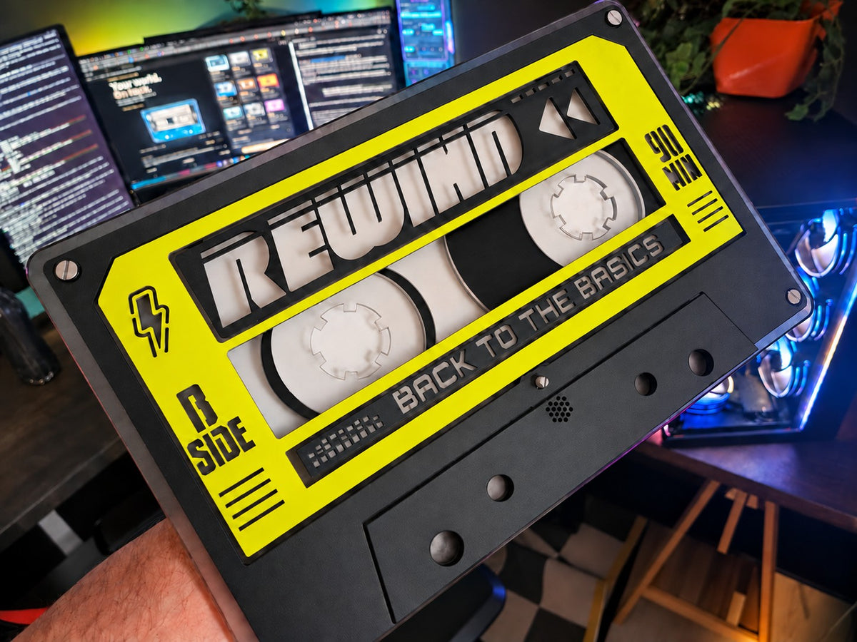 Unlit custom REWIND cassette in yellow and black, angled close up