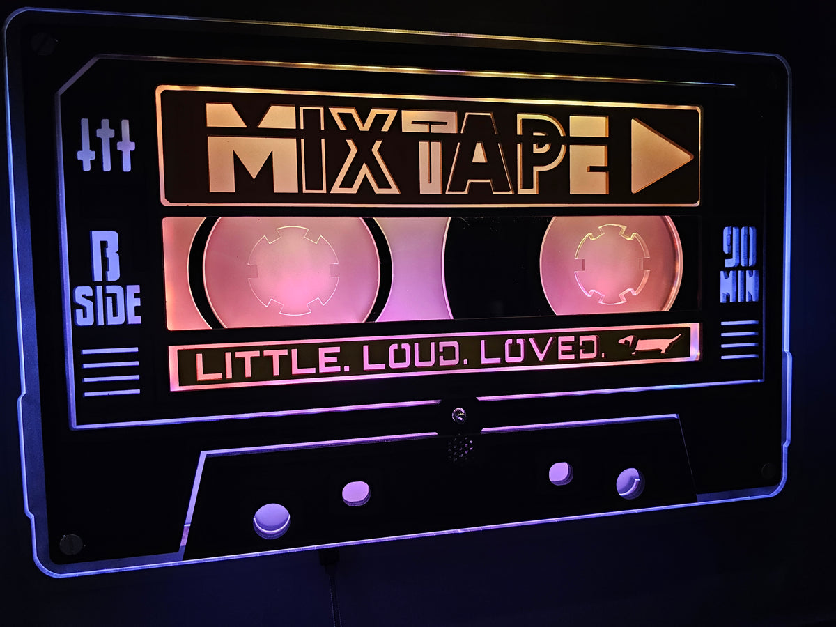 Custom MIXTAPE cassette in warm pink light, close up