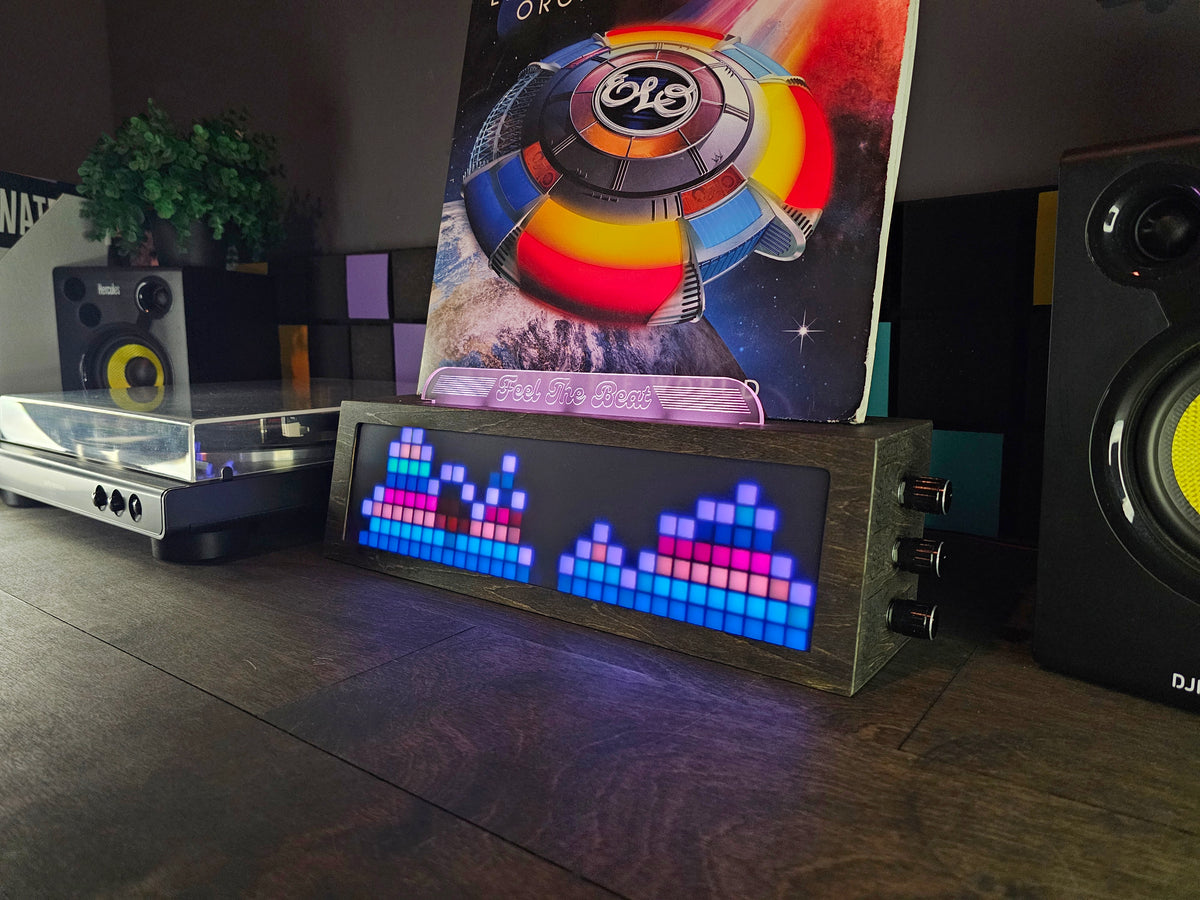 LEDCLAW Vinyl Visualizer Wide in Smoked Black showing a sound-reactive spectrum under a vinyl record, Feel The Beat top panel lit