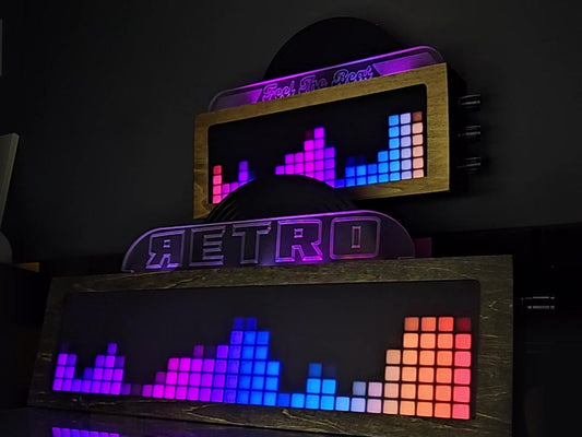 Two LEDCLAW Vinyl Visualizers playing sound-reactive light animations and scrolling Feel The Beat text