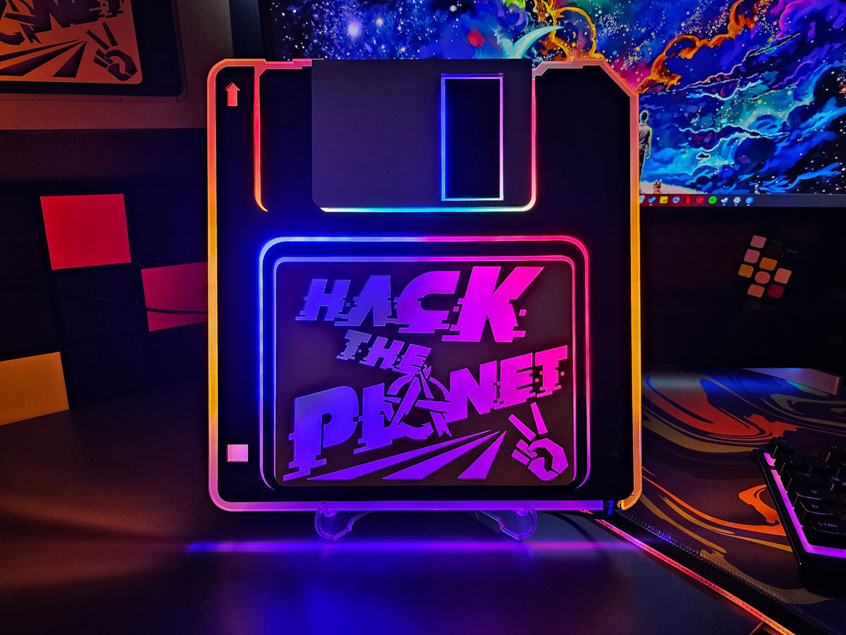 Illuminated Hack the Planet floppy disk on a gaming desk